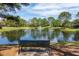 A serene pond with a fountain and a bench offers a peaceful spot to enjoy the outdoors at 2106 Ridgewind Way, Windermere, FL 34786