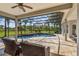 Stunning screened pool area with a covered lanai, comfortable seating, and a lush green backyard view at 2106 Ridgewind Way, Windermere, FL 34786