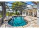 Beautiful pool area with screened enclosure, lush landscaping, and comfortable seating for relaxation at 2106 Ridgewind Way, Windermere, FL 34786