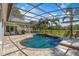 Inviting pool area with a screened lanai, palm trees, and a spacious backyard for outdoor activities at 2106 Ridgewind Way, Windermere, FL 34786