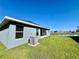 Backyard of home features screened-in porch and lush green grass with a water view at 2107 Cartgate Ln, Winter Haven, FL 33884