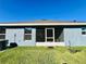 Backyard of home features screened-in porch and lush green grass at 2107 Cartgate Ln, Winter Haven, FL 33884