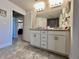 Double vanity bathroom features granite countertops and tile flooring, with natural light filling the space at 2107 Cartgate Ln, Winter Haven, FL 33884