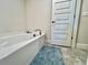 Bathtub featuring tile flooring and a blue bath mat at 2107 Cartgate Ln, Winter Haven, FL 33884