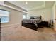 Calm and relaxing bedroom with plush carpet, tray ceiling, and two windows at 2107 Cartgate Ln, Winter Haven, FL 33884