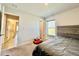 Cozy bedroom with carpet flooring, window with blinds and ensuite bathroom at 2107 Cartgate Ln, Winter Haven, FL 33884