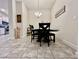 Cozy dining area with elegant table setting, modern lighting, and tile flooring at 2107 Cartgate Ln, Winter Haven, FL 33884