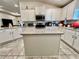 Spacious kitchen featuring white cabinets, stainless steel appliances, granite countertops, and an island at 2107 Cartgate Ln, Winter Haven, FL 33884