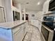 Open-concept kitchen with granite countertops, a stainless steel refrigerator, and a view of the breakfast nook at 2107 Cartgate Ln, Winter Haven, FL 33884