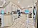 Well-appointed kitchen featuring white cabinetry, stainless steel appliances, and ample counter space at 2107 Cartgate Ln, Winter Haven, FL 33884