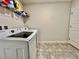 Bright laundry room with tile floors, washer, dryer and storage shelf at 2107 Cartgate Ln, Winter Haven, FL 33884