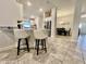 Open-concept living room with breakfast bar, showing a dining table in the background at 2107 Cartgate Ln, Winter Haven, FL 33884