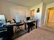 Home office featuring multiple monitors, carpet flooring, and neutral walls at 2107 Cartgate Ln, Winter Haven, FL 33884