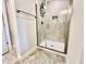 Shower featuring gray tile, glass door, and a recessed niche for storage at 2107 Cartgate Ln, Winter Haven, FL 33884