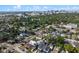 Aerial view of neighborhood with lush trees and cityscape in the background at 2108 Delaney Ave, Orlando, FL 32806