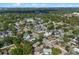 Bird's eye view of home situated within a tree-lined neighborhood with green lawns at 2108 Delaney Ave, Orlando, FL 32806