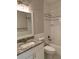 Bright bathroom with a granite topped white vanity next to a bathtub and shower combination at 2108 Delaney Ave, Orlando, FL 32806