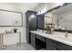 Stylish bathroom featuring a double vanity with black cabinets, gold fixtures, and a decorative tile floor at 2108 Delaney Ave, Orlando, FL 32806