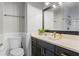 Elegant bathroom featuring a black vanity with marble countertop and gold faucet at 2108 Delaney Ave, Orlando, FL 32806