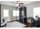 Bedroom featuring a sliding door closet, a desk area, and two windows for great natural light at 2108 Delaney Ave, Orlando, FL 32806