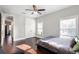 Bright bedroom featuring hardwood floors, a ceiling fan, and a large window with natural light at 2108 Delaney Ave, Orlando, FL 32806