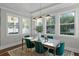 Bright dining area featuring modern decor, an area rug, and a large window at 2108 Delaney Ave, Orlando, FL 32806