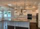 Gourmet kitchen showcasing an oversized island, pendant lighting, and stainless steel appliances at 2108 Delaney Ave, Orlando, FL 32806