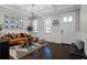 Cozy living room with hardwood floors, modern light fixture, and stylish furnishings at 2108 Delaney Ave, Orlando, FL 32806