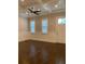 Bright room featuring hardwood floors, paneled walls, and a ceiling fan at 2108 Delaney Ave, Orlando, FL 32806