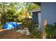 Cozy backyard featuring potted plants, an umbrella, and various outdoor decor, creating a relaxing space at 2525 S Sanford Avenue Ave, Sanford, FL 32773