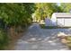 Gravel driveway leading to the property, surrounded by trees and a fence, offering a sense of privacy at 2525 S Sanford Avenue Ave, Sanford, FL 32773