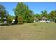 Expansive front yard with mature trees and a charming home with a welcoming porch, adding curb appeal at 2525 S Sanford Avenue Ave, Sanford, FL 32773