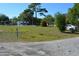 Vacant lot featuring lush greenery and mature trees with neighborhood houses shown in the background at 2525 S Sanford Avenue Ave, Sanford, FL 32773