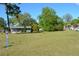 Expansive green lot featuring mature trees, with an adjacent charming home shown on the property at 2525 S Sanford Avenue Ave, Sanford, FL 32773