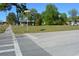 Wide street view showcases a vacant lot among neighborhood houses and a passing traffic at 2525 S Sanford Avenue Ave, Sanford, FL 32773