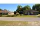 Street view of two residential homes with green lawns, landscaping, and blue sky at 2525 S Sanford Avenue Ave, Sanford, FL 32773