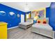 Vibrant blue bedroom with two beds, a chandelier, and 