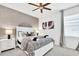 Relaxing bedroom featuring a decorative gray accent wall, a plush queen bed, and a nightstand at 2557 Shanti Dr, Kissimmee, FL 34746