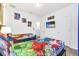 Shared bedroom featuring two beds, colorful Marvel-themed bedding, and playful superhero artwork at 2557 Shanti Dr, Kissimmee, FL 34746