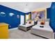 This bedroom features two beds and bright blue wall and a mural from Beauty and the Beast at 2557 Shanti Dr, Kissimmee, FL 34746