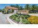 Veranda Palms entrance with manicured landscaping, signage, and a guard house under a sunny sky at 2557 Shanti Dr, Kissimmee, FL 34746