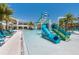 Community pool area with a water slide feature, surrounded by lounge chairs and palm trees at 2557 Shanti Dr, Kissimmee, FL 34746