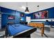 The ultimate game room features a billiards table, foosball, blue paint and ample entertainment at 2557 Shanti Dr, Kissimmee, FL 34746