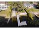 Aerial view of backyard dock with seating, hedgerow, and mature trees on a sunny day at 2661 Jennifer Hope Blvd, Longwood, FL 32779