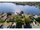 Aerial view of neighborhood with lake access and docks near mature trees and lawns at 2661 Jennifer Hope Blvd, Longwood, FL 32779