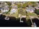 Aerial view of waterfront home with a dock and pool surrounded by lush lawns and mature trees at 2661 Jennifer Hope Blvd, Longwood, FL 32779