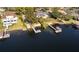 Aerial view of waterfront home with a dock, landscaping, and neighboring houses at 2661 Jennifer Hope Blvd, Longwood, FL 32779