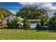 Lush backyard view with tropical plants and an enclosed patio, great for relaxation and privacy at 2661 Jennifer Hope Blvd, Longwood, FL 32779