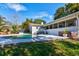 Backyard view of the home features an in-ground pool, patio, and screened in back porch at 2661 Jennifer Hope Blvd, Longwood, FL 32779