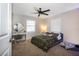 Comfortable bedroom featuring carpet flooring, ceiling fan, and natural light through windows at 2661 Jennifer Hope Blvd, Longwood, FL 32779